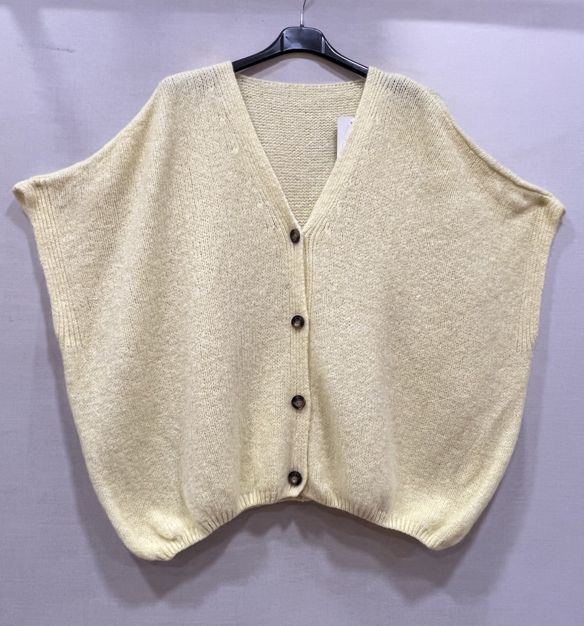 Loose-fitting cardigan with 3/4 sleeves, button closure, and enveloping comfort