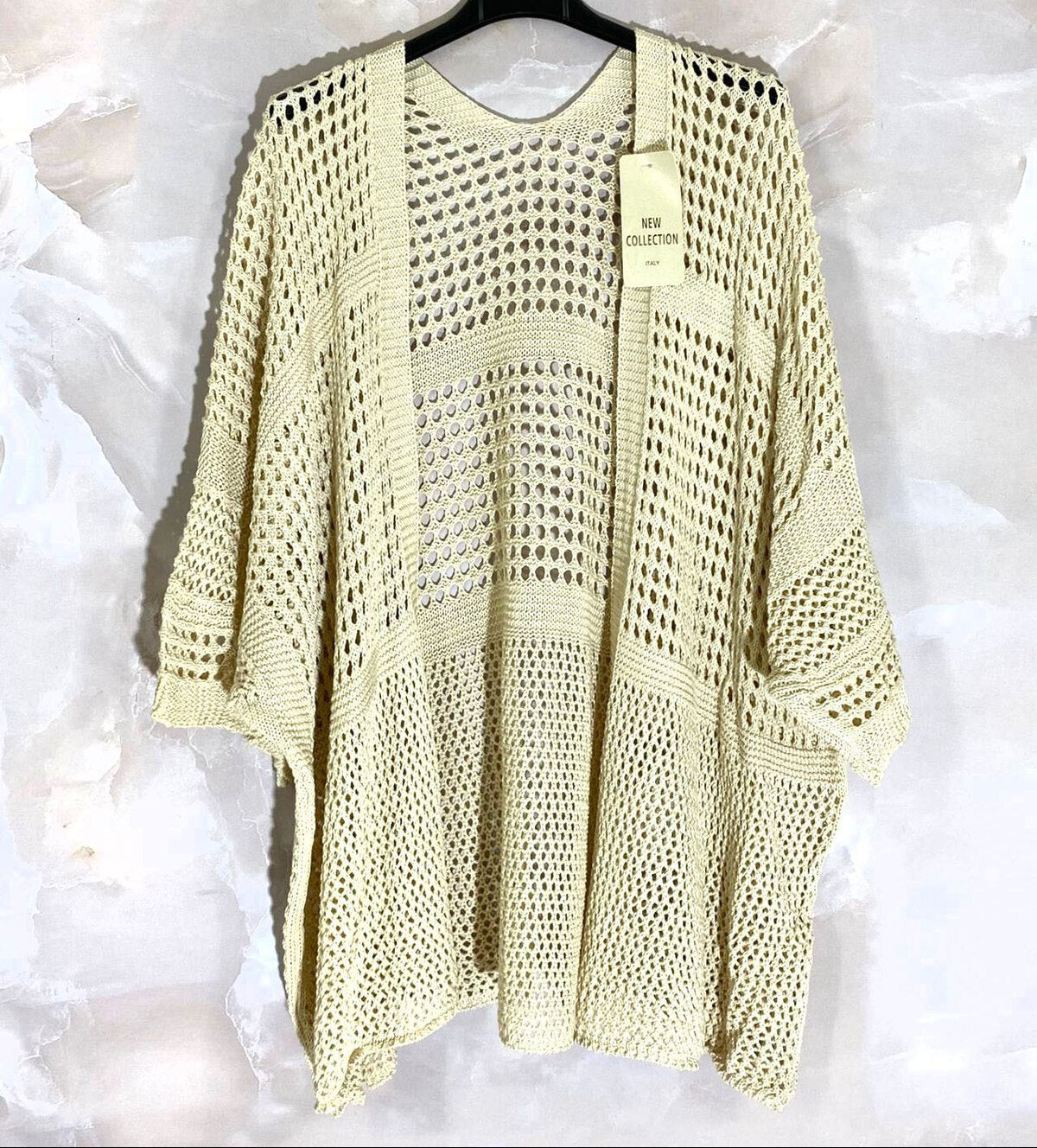 Loose-fitting cardigan with 3/4 sleeves, button closure, and enveloping comfort