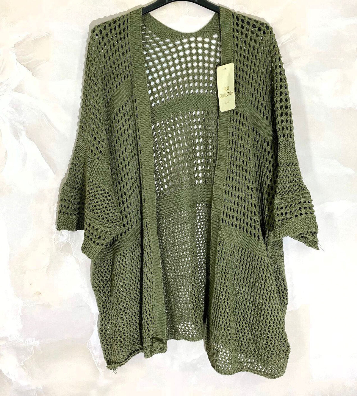 Loose-fitting cardigan with 3/4 sleeves, button closure, and enveloping comfort