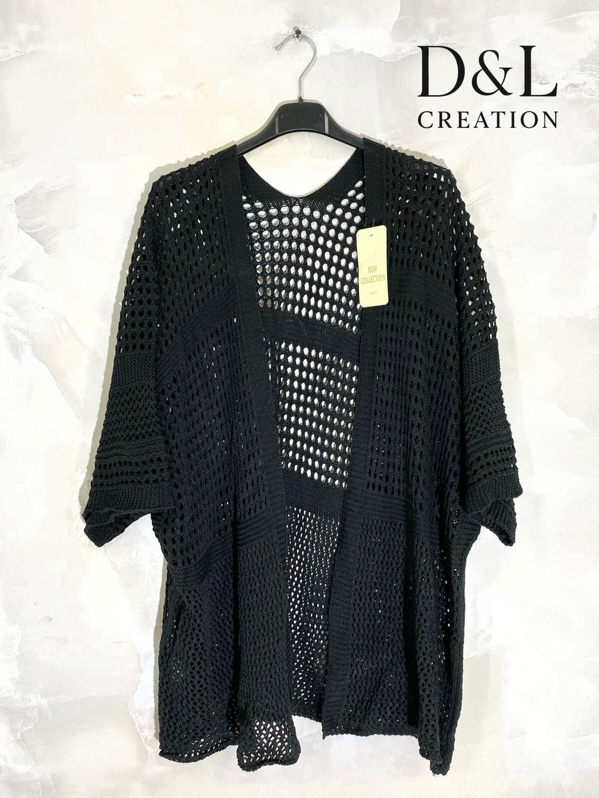 Loose-fitting cardigan with 3/4 sleeves, button closure, and enveloping comfort