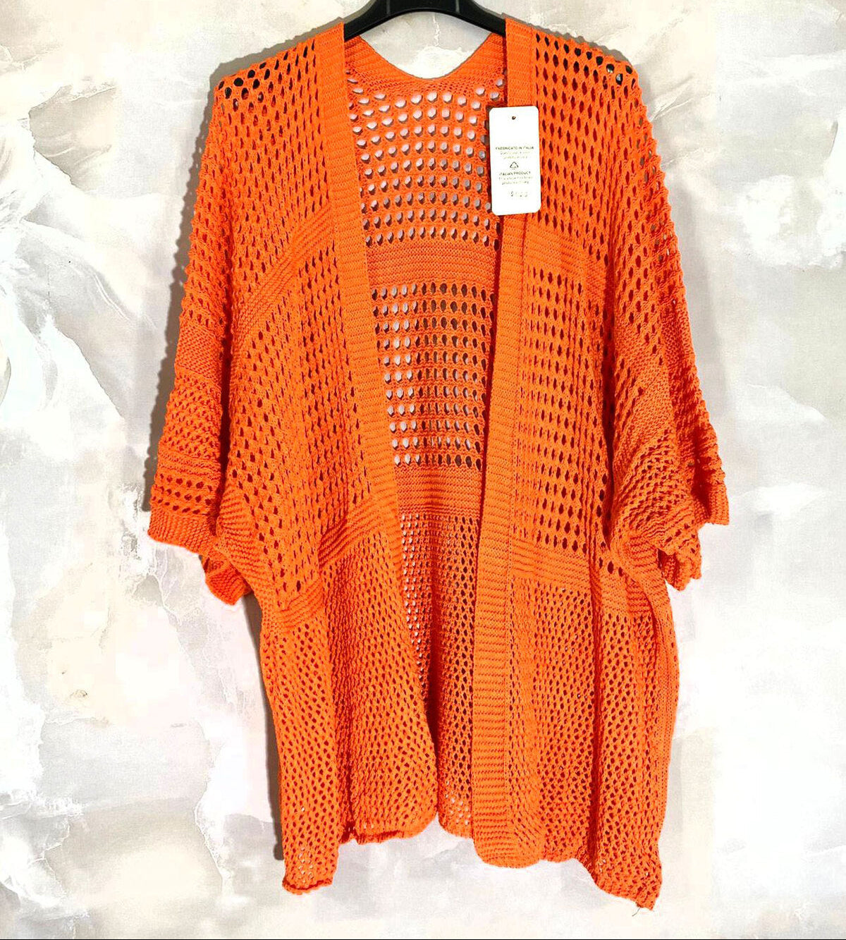 Loose-fitting cardigan with 3/4 sleeves, button closure, and enveloping comfort
